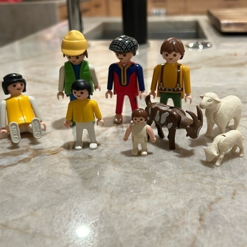 Playmobil figures- family members. 4 adults, 1 child, 1 baby, 1 goat, 2 sheep.